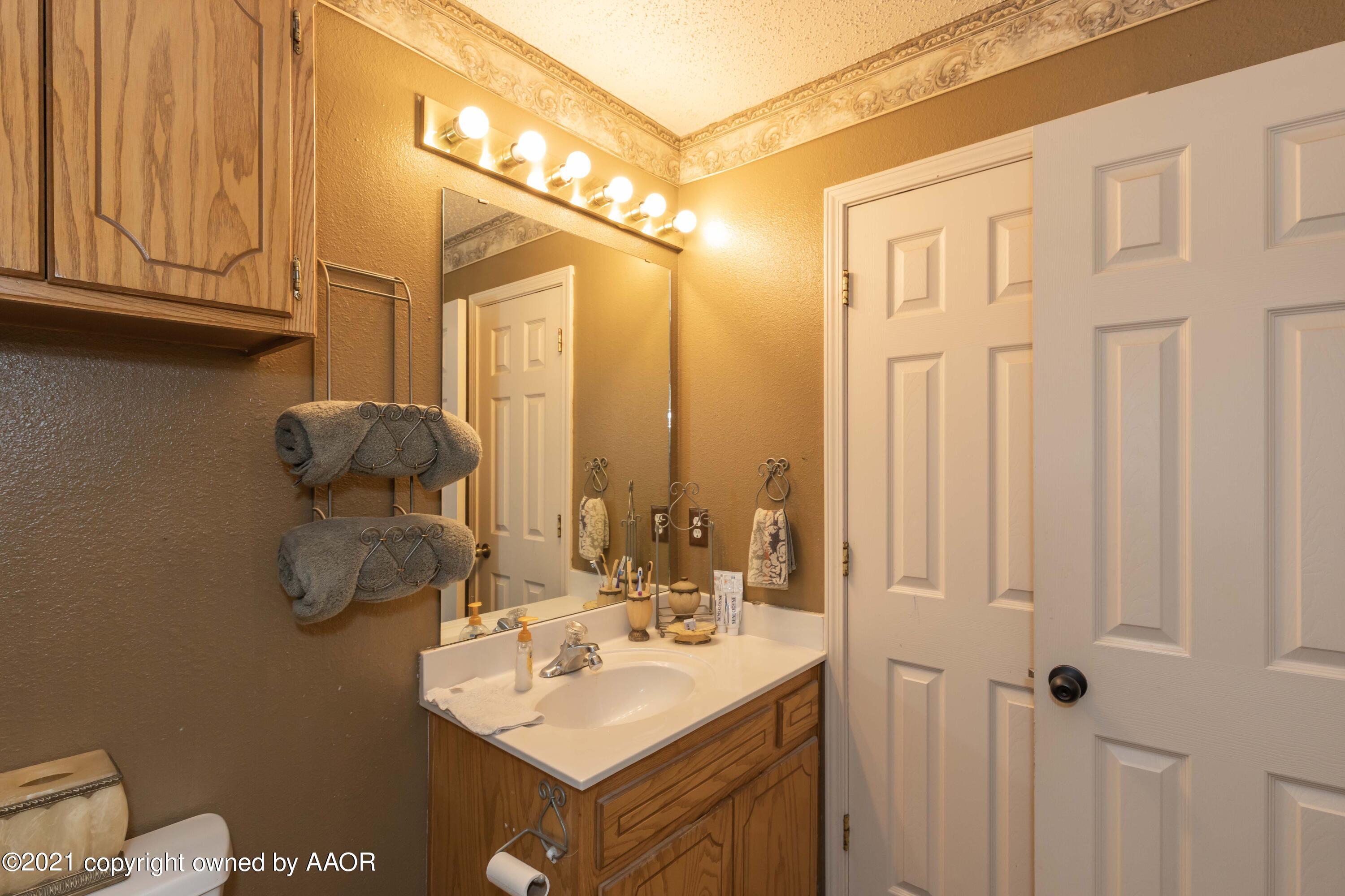 1025 Ketler Street Amarillo, TX 79104 - Photo 19 of 31 a bathroom with a sink vanity and mirror