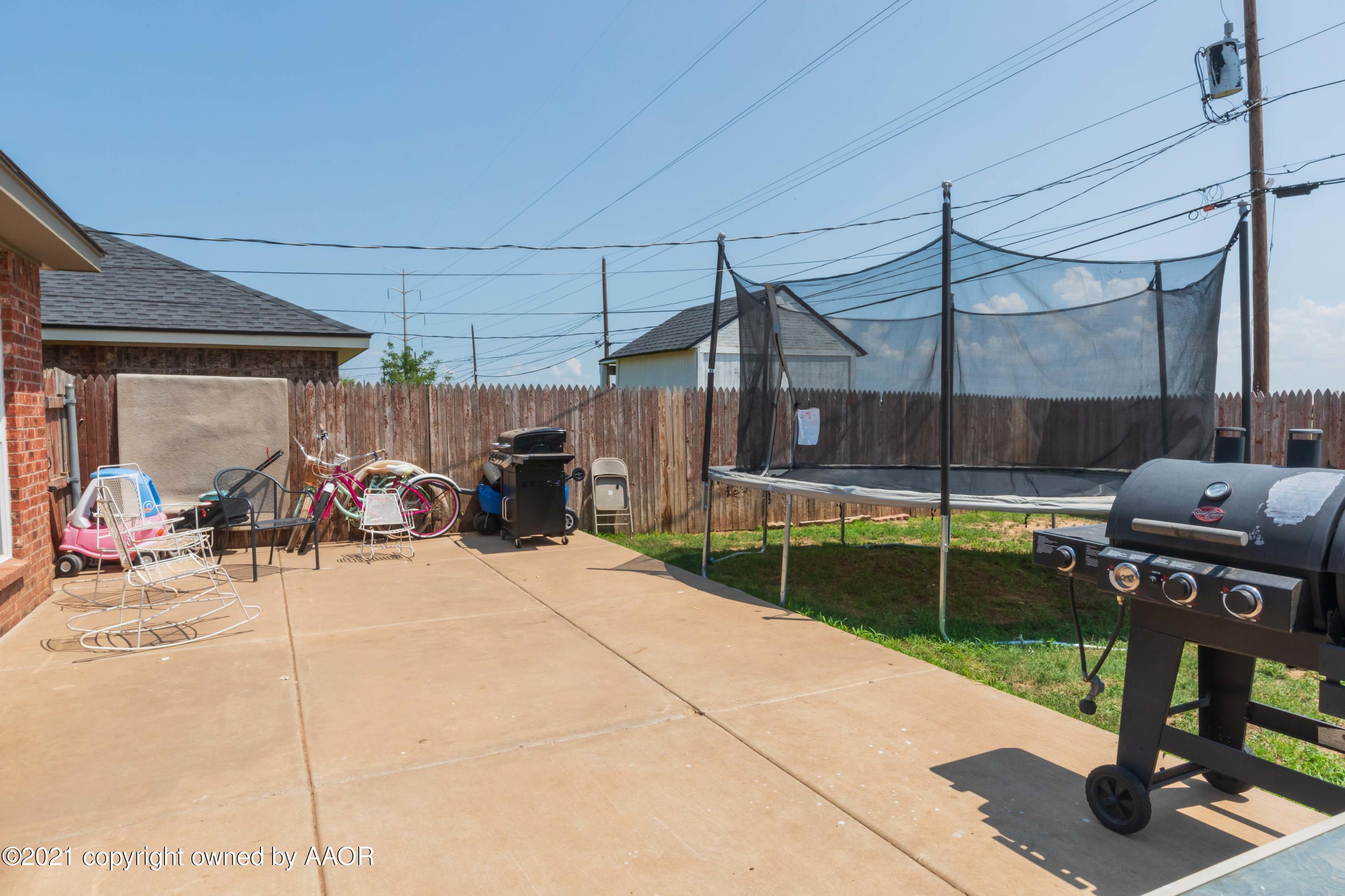 1025 Ketler Street Amarillo, TX 79104 - Photo 29 of 31 a view of a patio with table and chairs under an umbrella