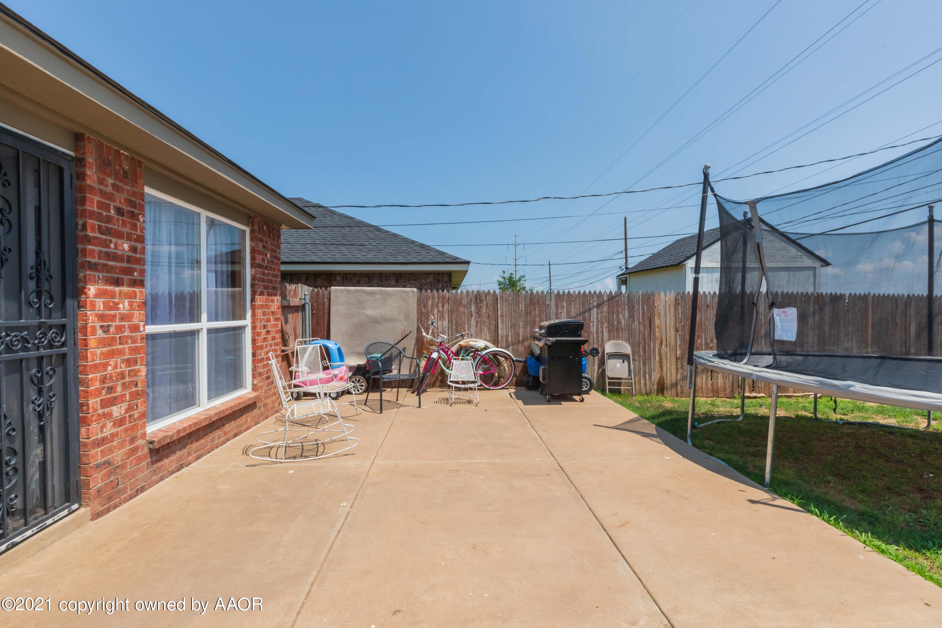 1025 Ketler Street Amarillo, TX 79104 - Photo 31 of 31 a view of a patio with table and chairs under an umbrella