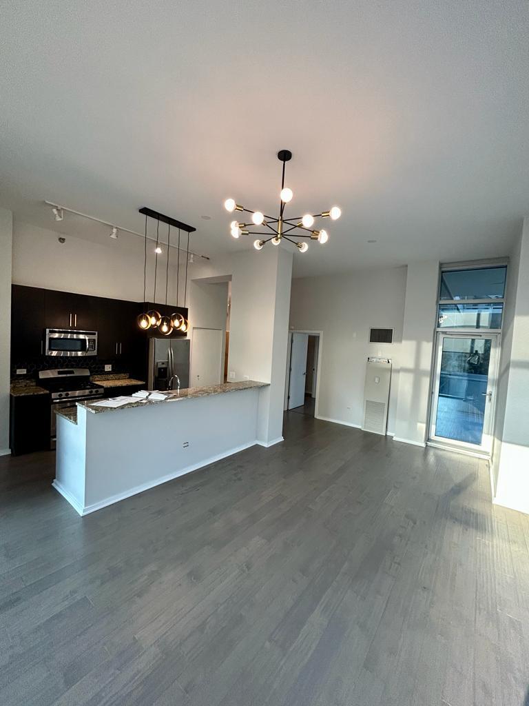 123 South Green Street, Unit 208B Chicago, IL 60607 - Photo 5 of 17 a view of kitchen with sink microwave and cabinets