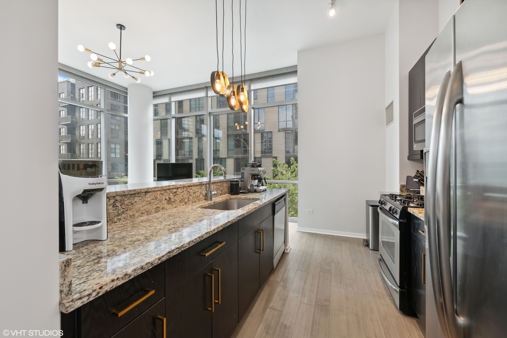 123 South Green Street, Unit 208B Chicago, IL 60607 - Photo 6 of 17 a kitchen with granite countertop counter top space a sink stainless steel appliances and cabinets