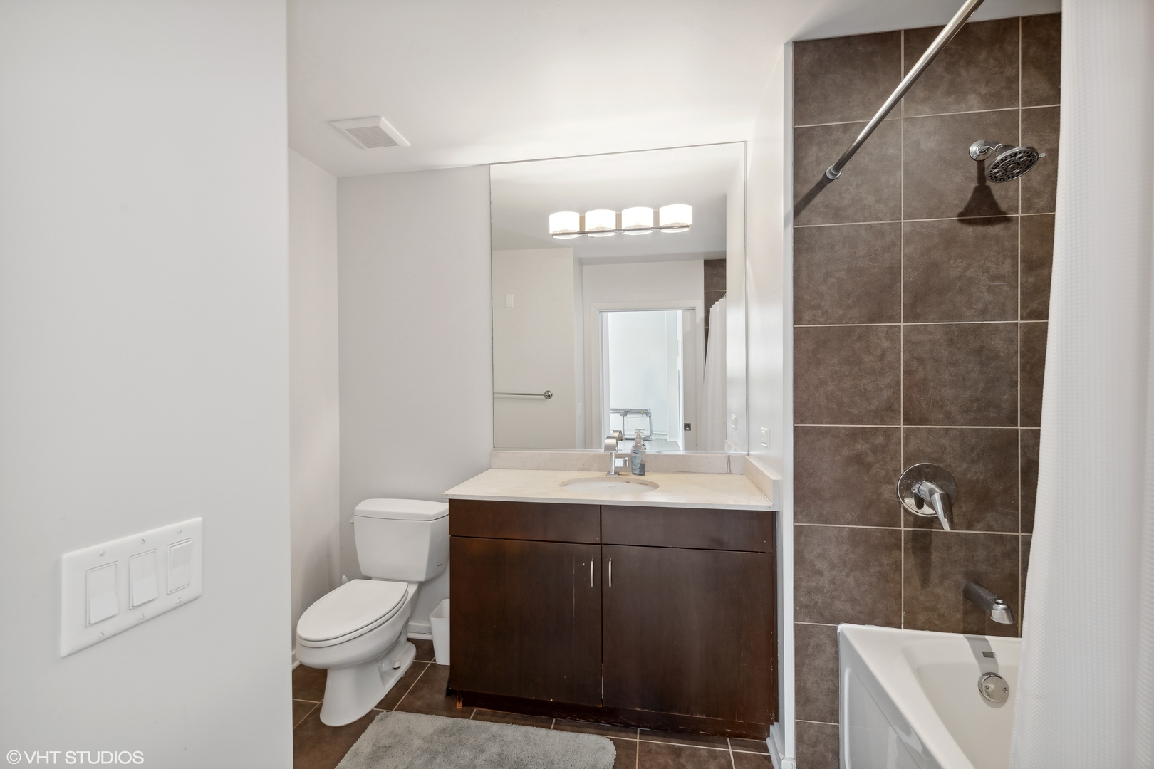 123 South Green Street, Unit 208B Chicago, IL 60607 - Photo 10 of 17 a bathroom with a sink a toilet and shower