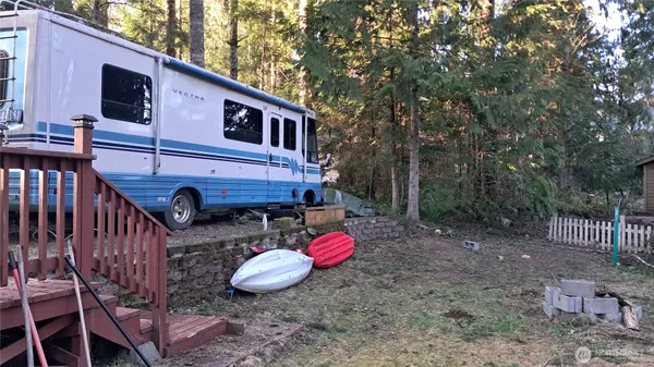 a view of a chairs and table in the backyard