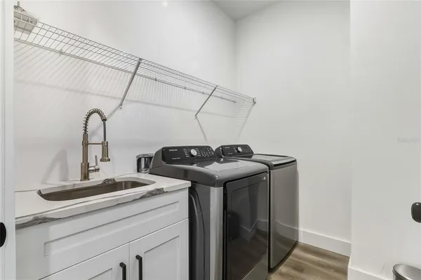 a bathroom with a granite countertop sink a mirror a bathtub and shower