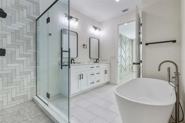 a bathroom with a double vanity sink a mirror and shower