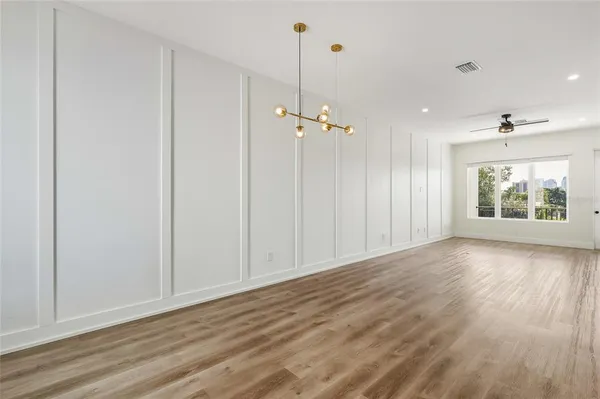 a view of a room with wooden floor and window