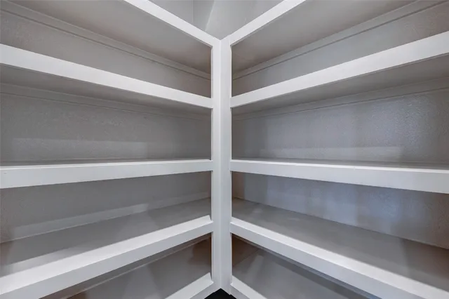 a view of large kitchen with wooden floor and window