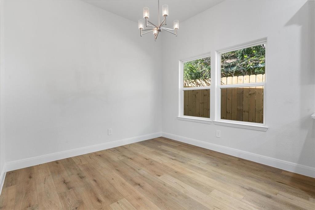 4715 Ramey Avenue Fort Worth, TX 76105 - Photo 13 of 32 wooden floor in an empty room with a window