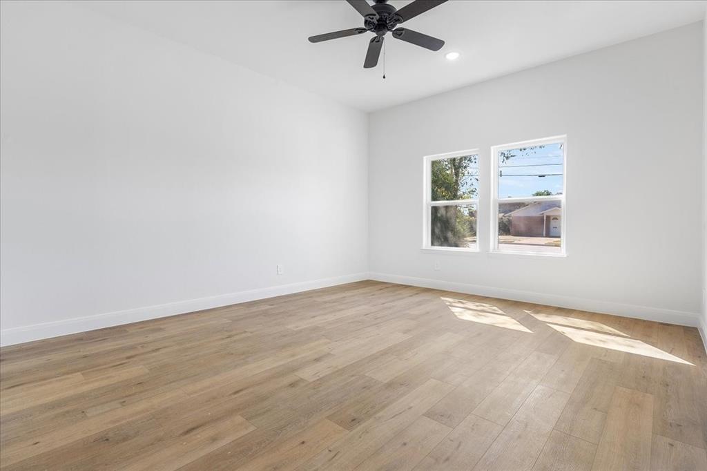 4715 Ramey Avenue Fort Worth, TX 76105 - Photo 14 of 32 a view of a big room with wooden floor and windows in a room