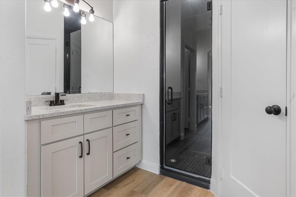4715 Ramey Avenue Fort Worth, TX 76105 - Photo 18 of 32 a bathroom with a shower sink and mirror