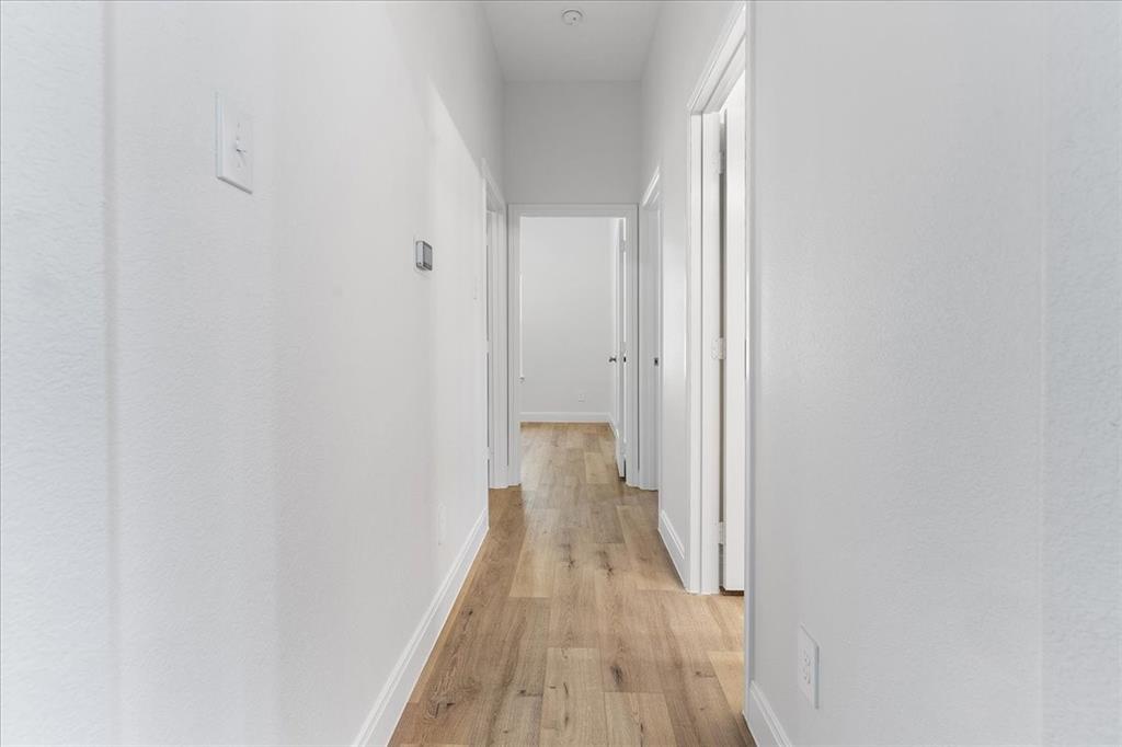 4715 Ramey Avenue Fort Worth, TX 76105 - Photo 23 of 32 a view of a hallway with wooden floor