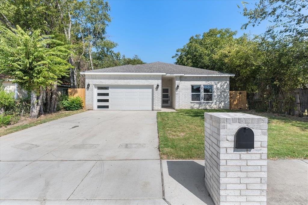 4715 Ramey Avenue Fort Worth, TX 76105 - Photo 3 of 32 a front view of house with yard and trees in the background