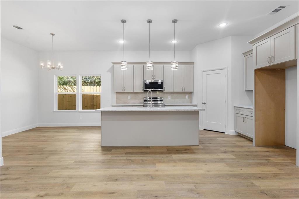 4715 Ramey Avenue Fort Worth, TX 76105 - Photo 8 of 32 a view living room with stainless steel appliances kitchen island wooden floor and window