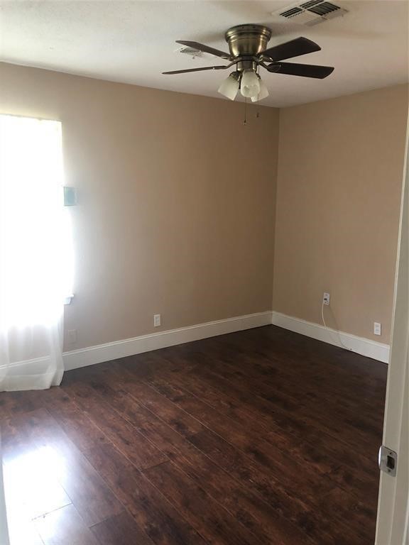 5631 Groveton Street Houston, TX 77033 - Photo 7 of 13 wooden floor in an empty room