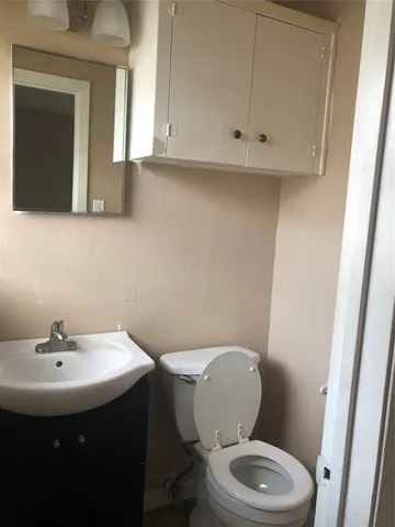a bathroom with a sink a mirror and a toilet