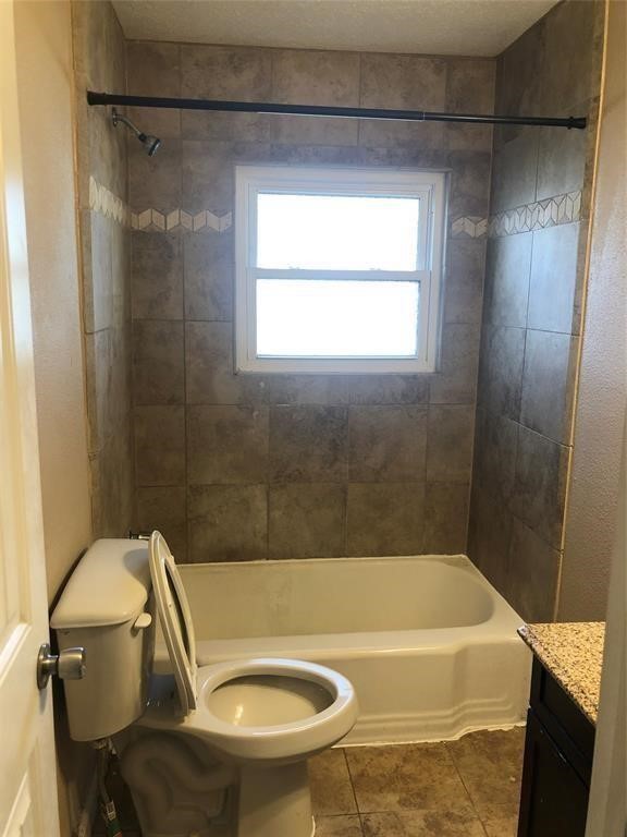 5631 Groveton Street Houston, TX 77033 - Photo 10 of 13 a bathroom with a sink and a bathtub