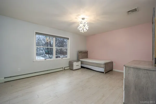 a spacious bedroom with a bed and a window