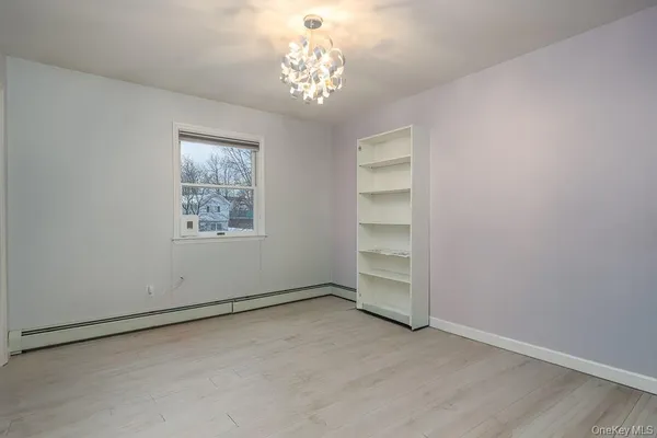 an empty room with a empty space and windows