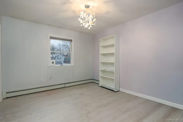 an empty room with a empty space and windows