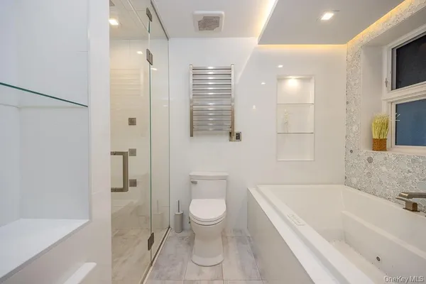 a bathroom with a bathtub a toilet and a shower