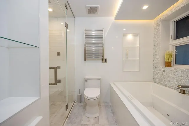 a bathroom with a bathtub a toilet and a shower