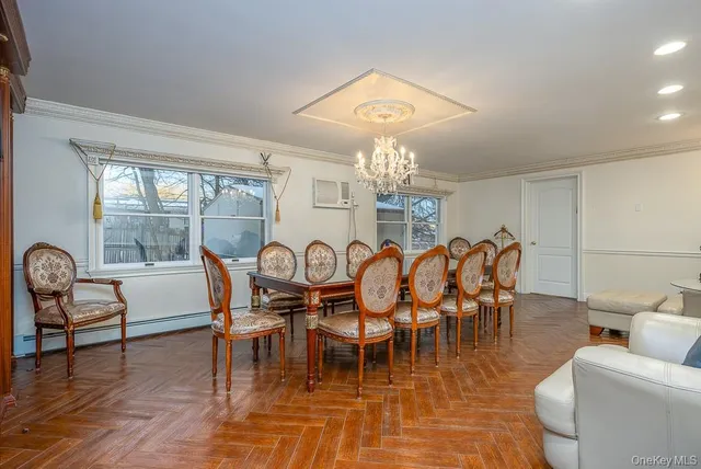 a view of a dining room with furniture a chandelier and wooden floor