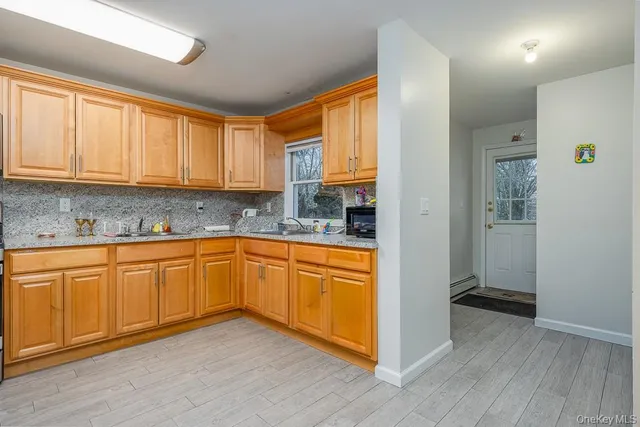 a kitchen with granite countertop wooden cabinets a sink and dishwasher