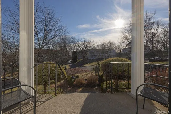 a view of balcony with two chairs and a table