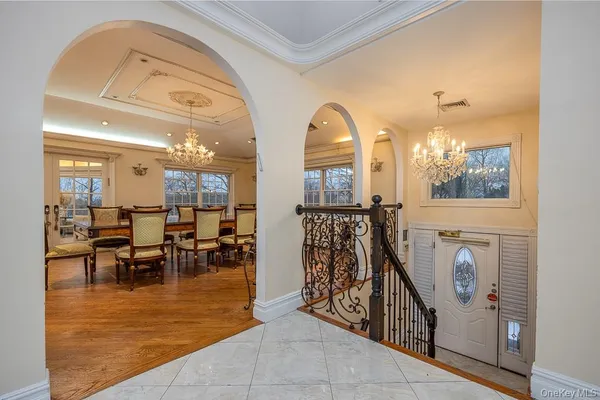 a view of a livingroom with furniture a dinning room and windows