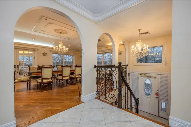 a view of a livingroom with furniture a dinning room and windows