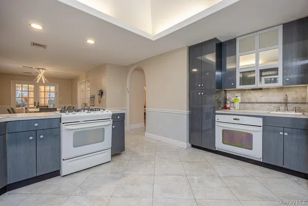 a kitchen with stainless steel appliances granite countertop a stove and a sink