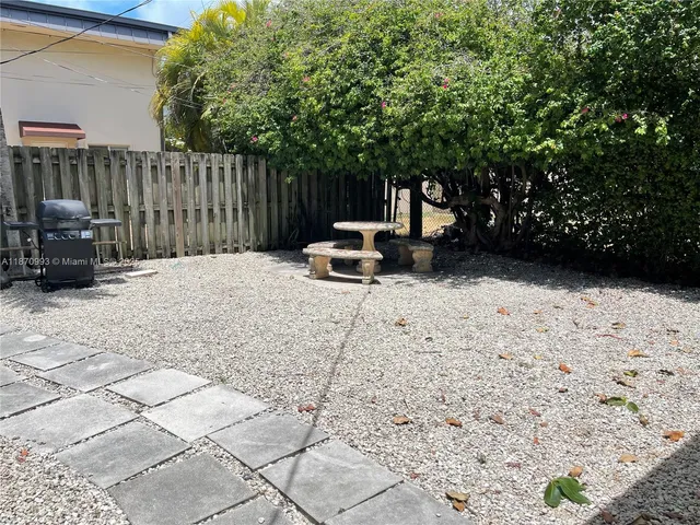 a white bench sitting in the middle of a yard