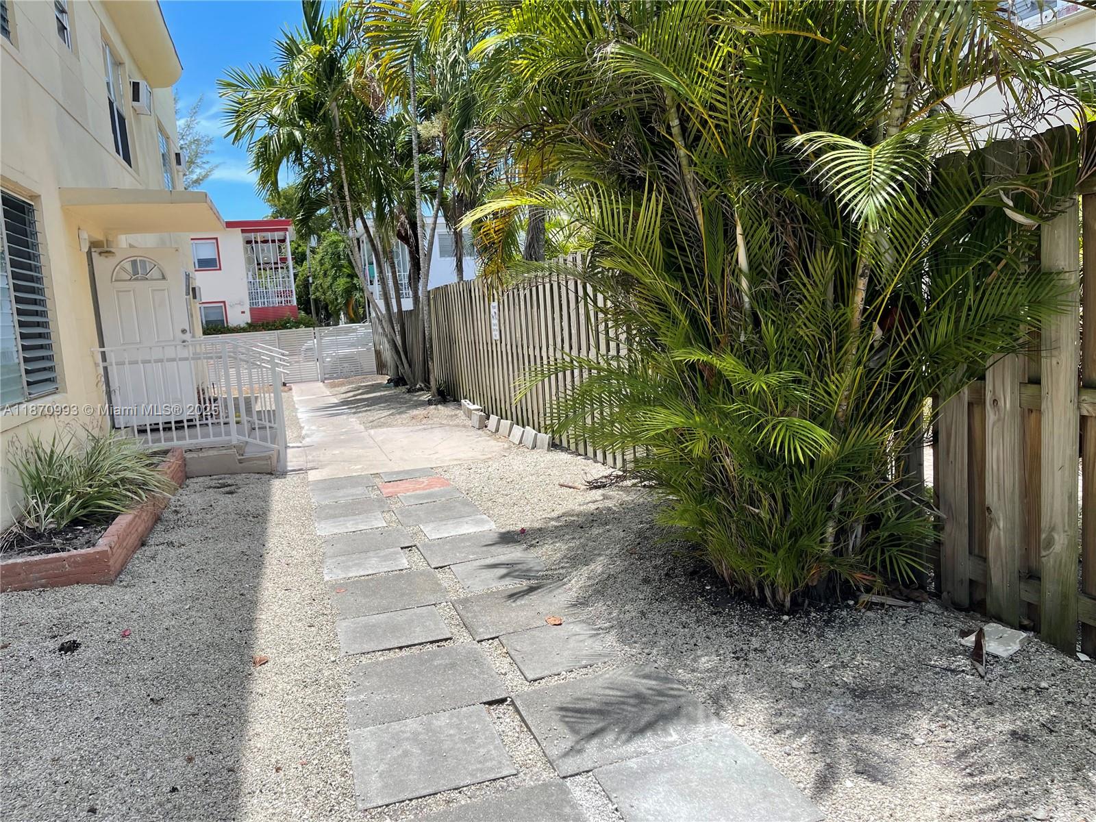 785 81st Street, Unit 3 Miami Beach, FL 33141 - Photo 12 of 12 a view of backyard with plants and trees