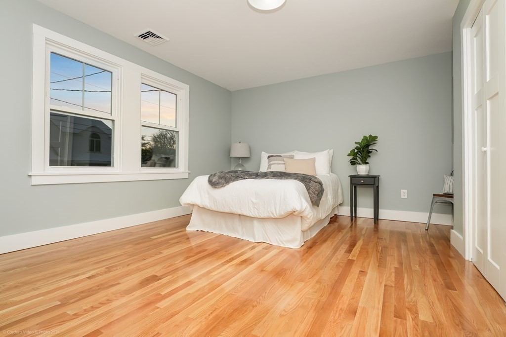 5 Harvard Street Fairhaven, MA 02719 - Photo 14 of 29 a spacious bedroom with a bed and wooden floor