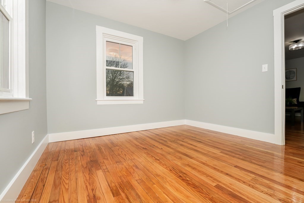 5 Harvard Street Fairhaven, MA 02719 - Photo 17 of 29 an empty room with wooden floor and windows