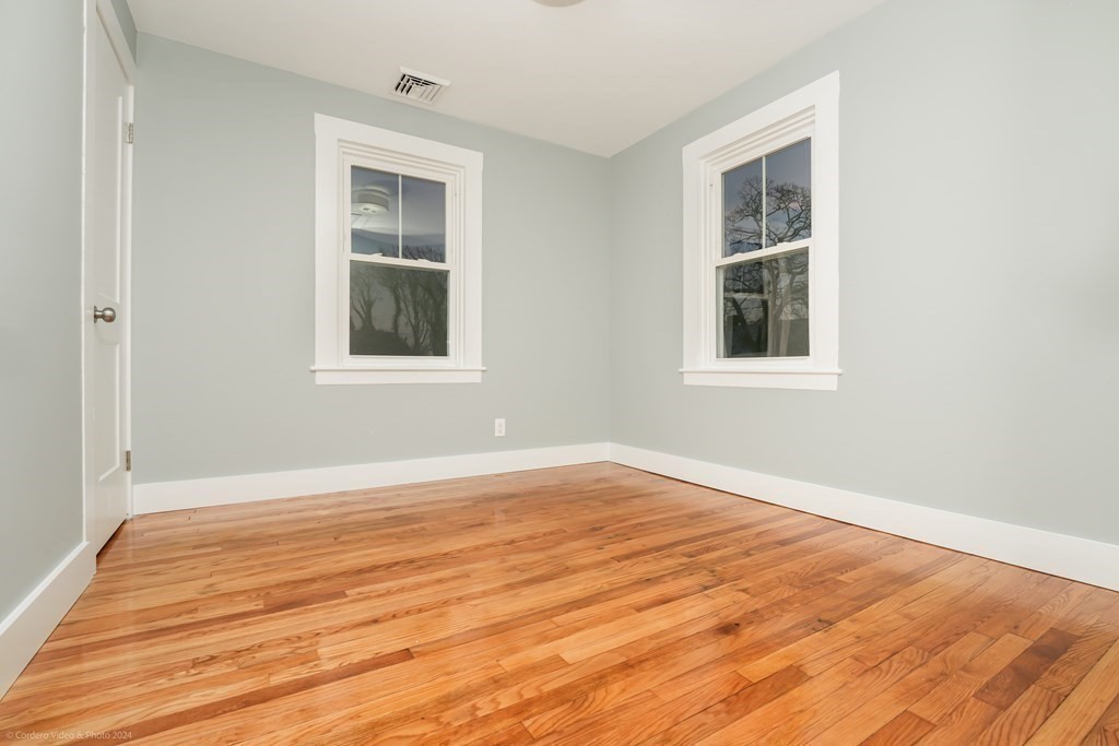5 Harvard Street Fairhaven, MA 02719 - Photo 18 of 29 an empty room with wooden floor and windows