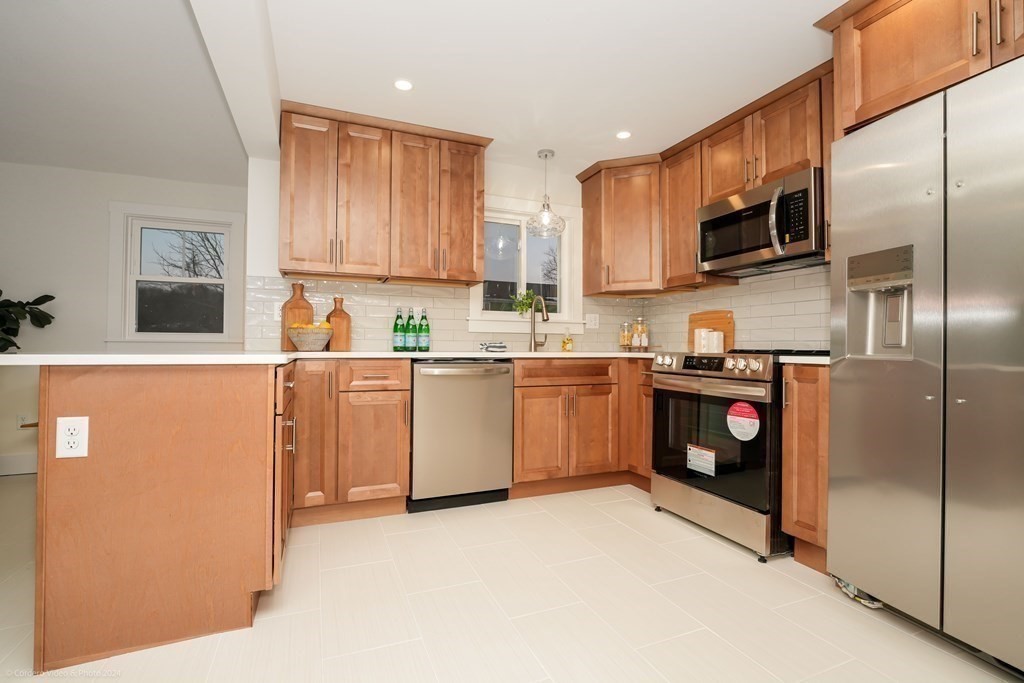 5 Harvard Street Fairhaven, MA 02719 - Photo 3 of 29 a kitchen with a sink a refrigerator and cabinets