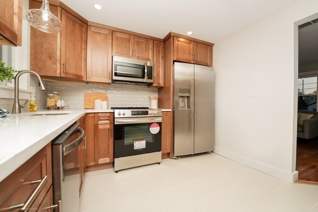 5 Harvard Street Fairhaven, MA 02719 - Photo 4 of 29 a kitchen with stainless steel appliances granite countertop a refrigerator stove and sink
