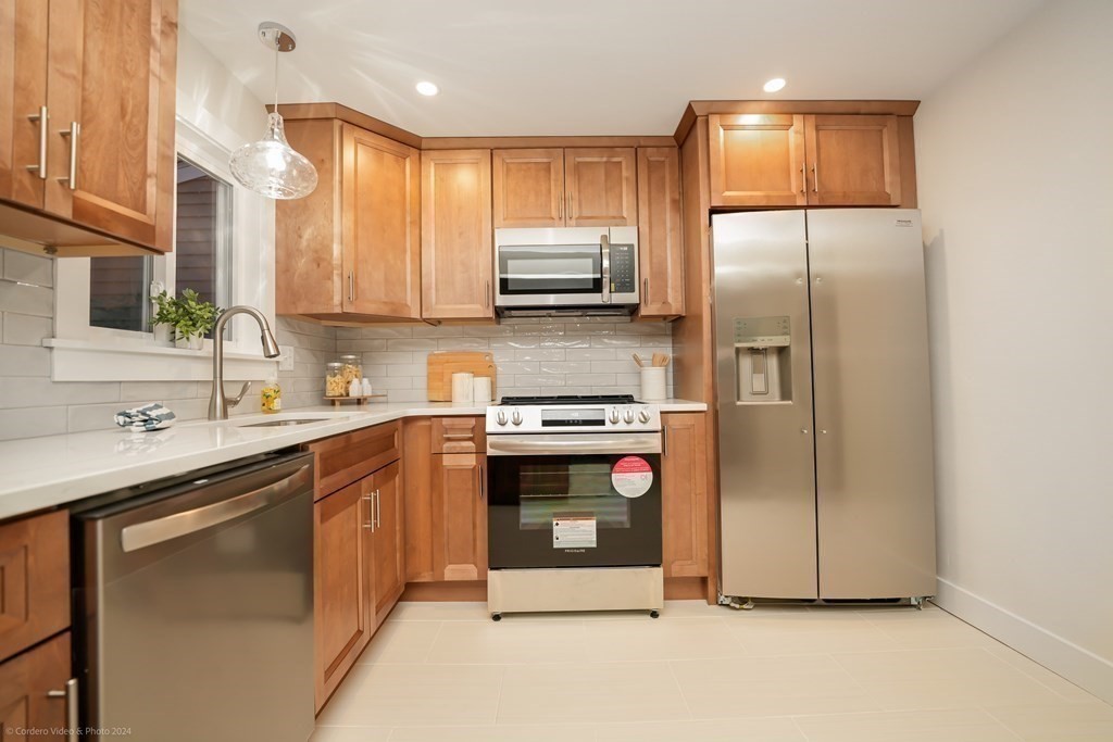 5 Harvard Street Fairhaven, MA 02719 - Photo 6 of 29 a kitchen with stainless steel appliances granite countertop a refrigerator a sink a stove and cabinets