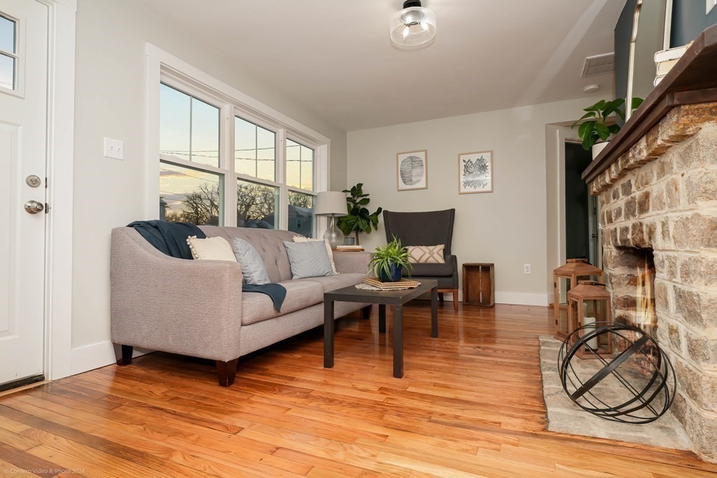5 Harvard Street Fairhaven, MA 02719 - Photo 10 of 29 a living room with furniture a flat screen tv and a floor to ceiling window