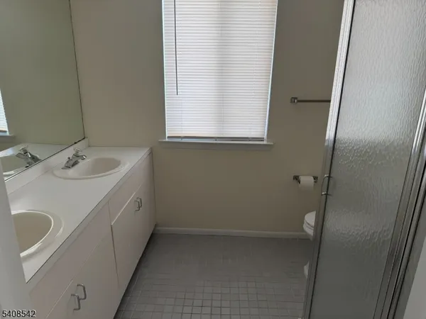 a bathroom with a sink a window and vanity