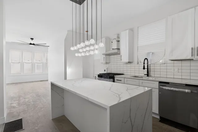 a kitchen with stainless steel appliances a sink a counter space and cabinets