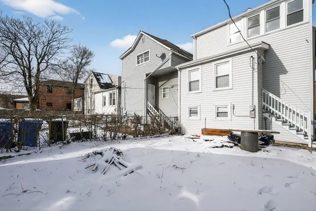 a view of a house with snow on the road