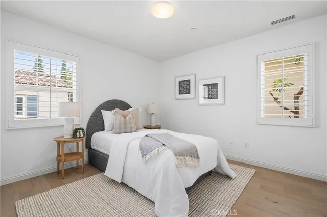 a bedroom with a bed and wall painting