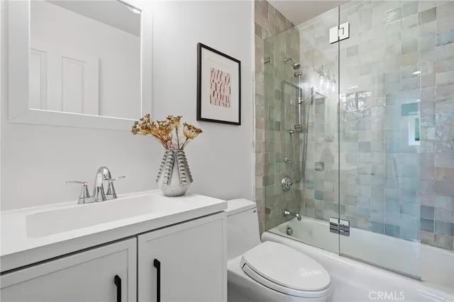a patio with table and chairs and potted plants