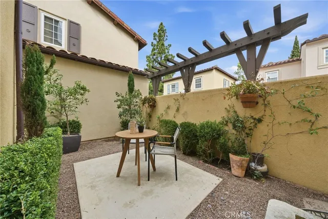 a view of a patio with table and chairs and potted plants