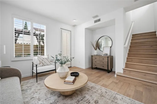 a dining room with furniture and potted plants