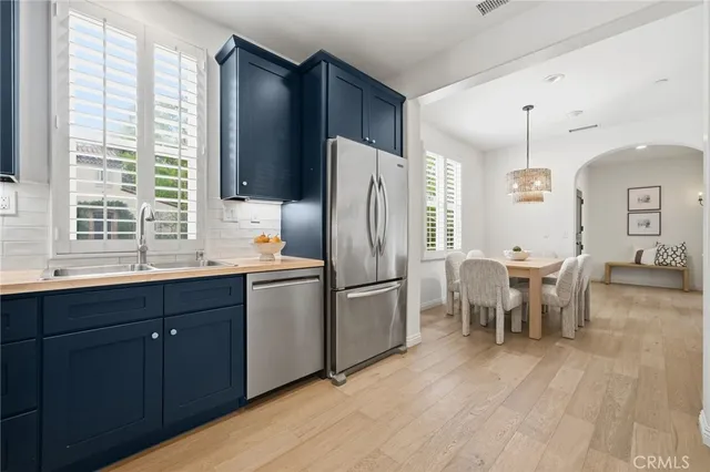 a kitchen with granite countertop wooden cabinets and stainless steel appliances