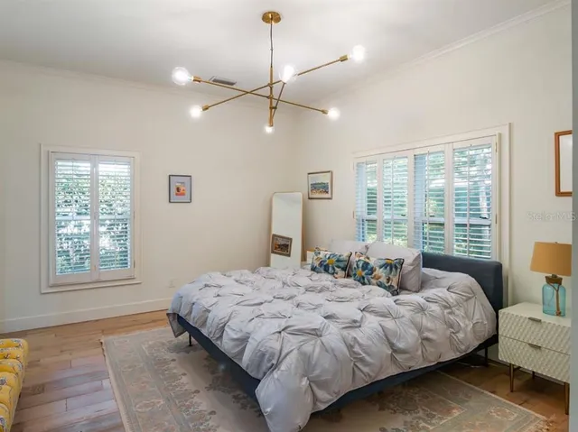 a bedroom with a large bed and a window