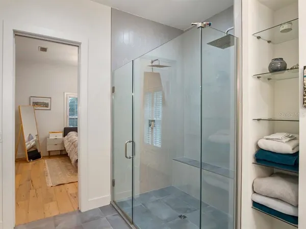 a bathroom with a shower and a sink